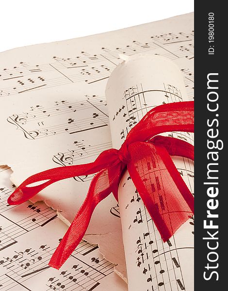 Theme music, old musical notes with roll bandaged red ribbon.