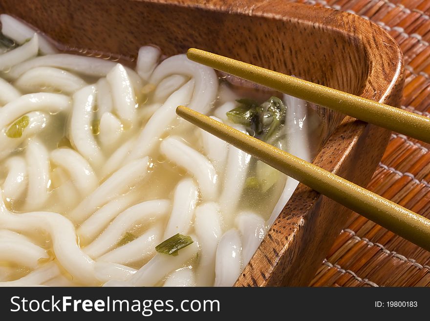 Asian noodle soup in a brown wooden bowl. Asian noodle soup in a brown wooden bowl.