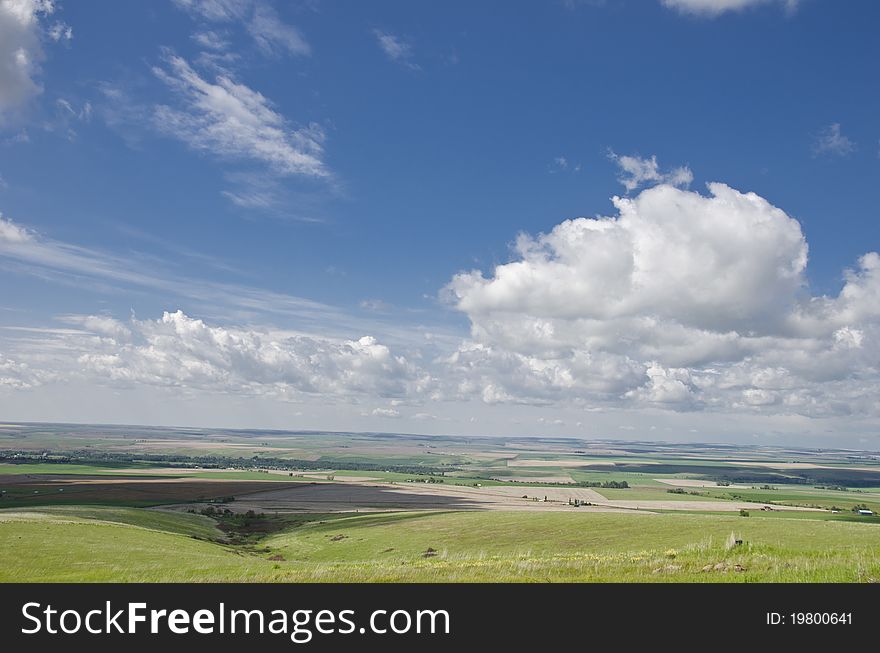 Wheat fields and hills under blue skies