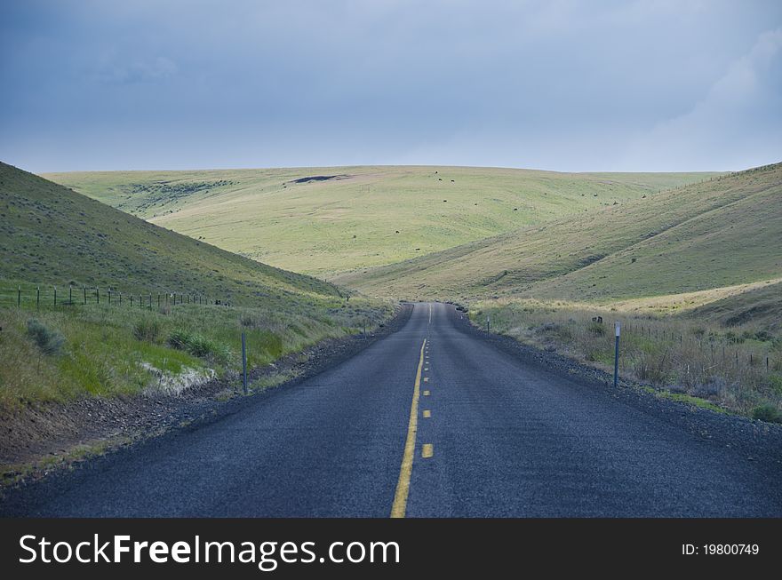Paved rural road through arid hills