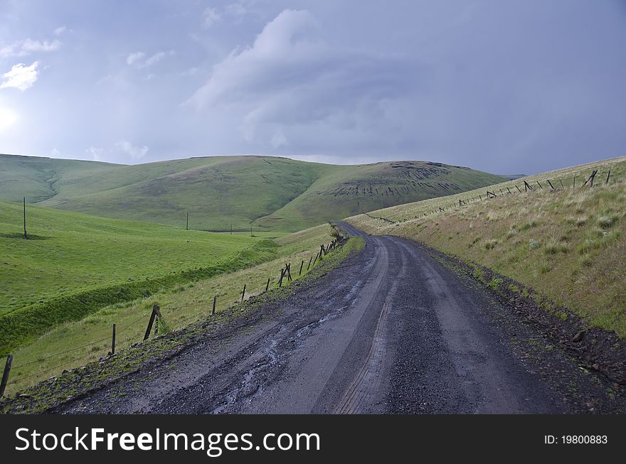 Gravel Rural Road Beneath Stormy Sky