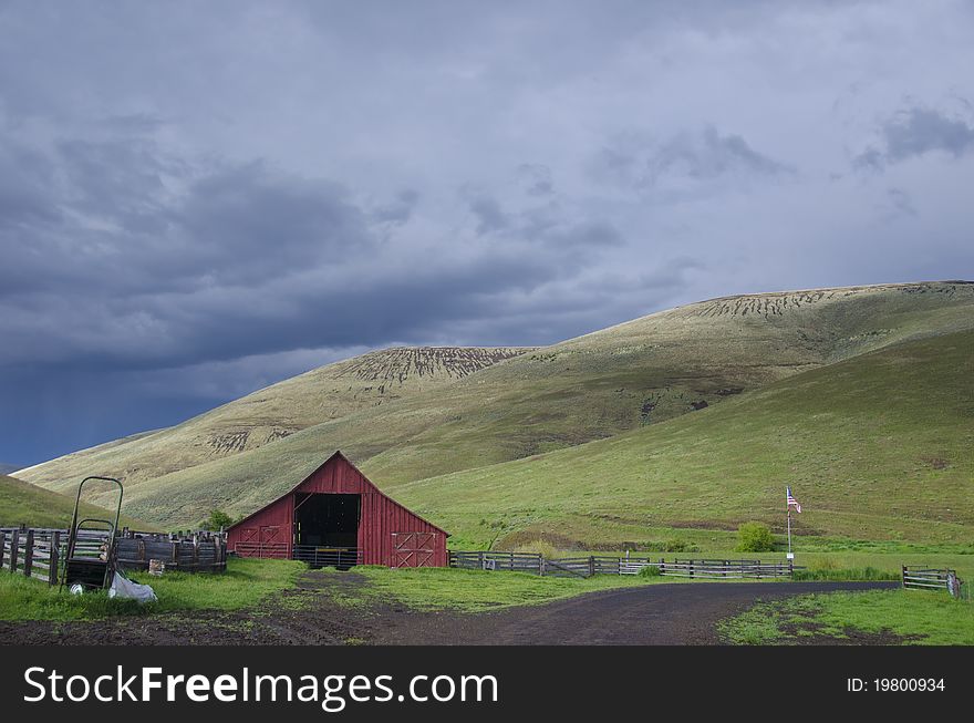 Red barn in dry hill western landscape