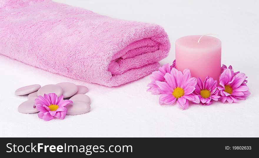 Aromatherapy still life with pink towel, candle, stones and flowers. Aromatherapy still life with pink towel, candle, stones and flowers