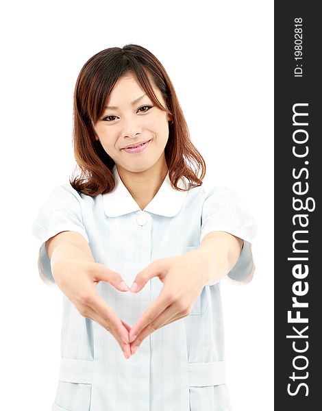 Young japanese female nurse shows fingers heart symbol. Young japanese female nurse shows fingers heart symbol