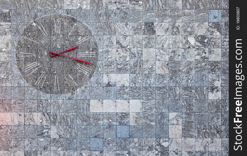 A marble wall clock found in Mainz, Germany. Suitable for images regarding time or texture backgrounds.