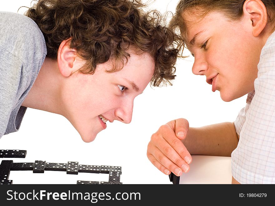 Boy and girl playing dominoes with fun