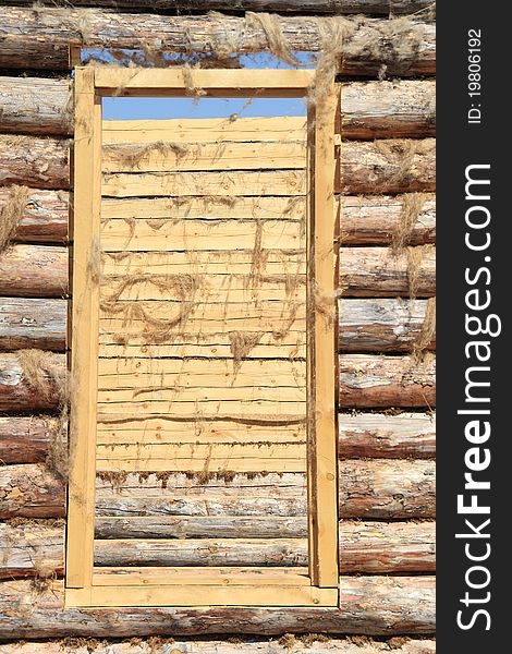 Doorway and the wall in an unfinished wooden house. Doorway and the wall in an unfinished wooden house.