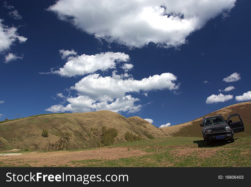 A SUV is in the mountain. A SUV is in the mountain