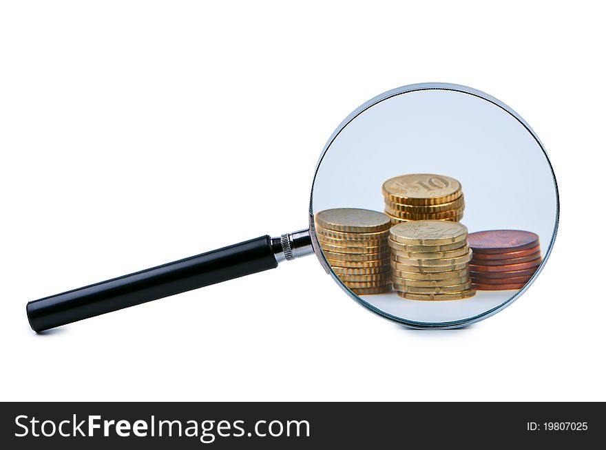 Magnifier and stack of coins isolated on white background shadow below. Magnifier and stack of coins isolated on white background shadow below.