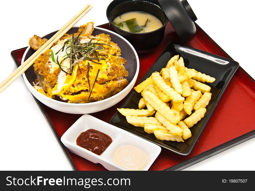 Bento, Japanese food style , fried chicken and  rice and soup and French fries on white background