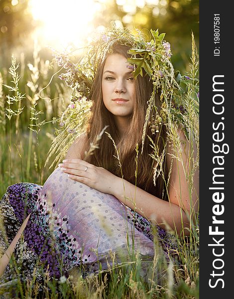 Portrait of woman sitting on grass in park