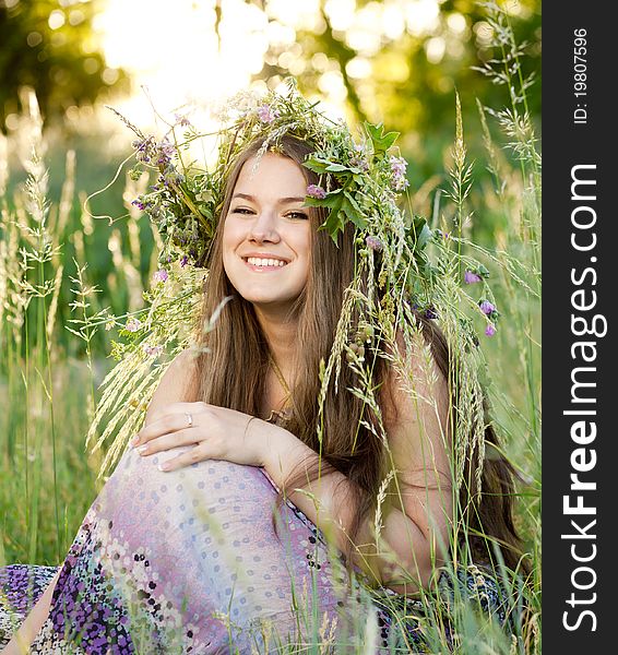 Portrait of woman sitting on grass in park