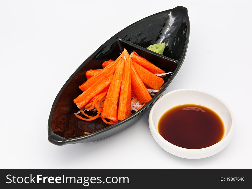 Japanese food style , crab stick and wasabi with sauce in the plate on white background