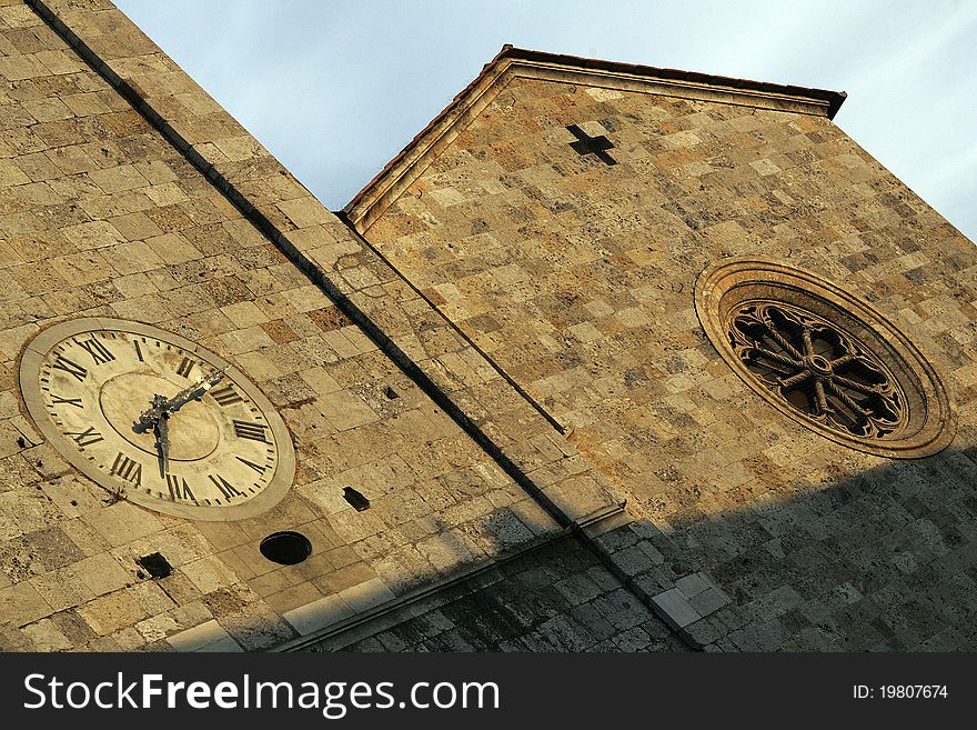 The old clock on the church in Italy. The old clock on the church in Italy