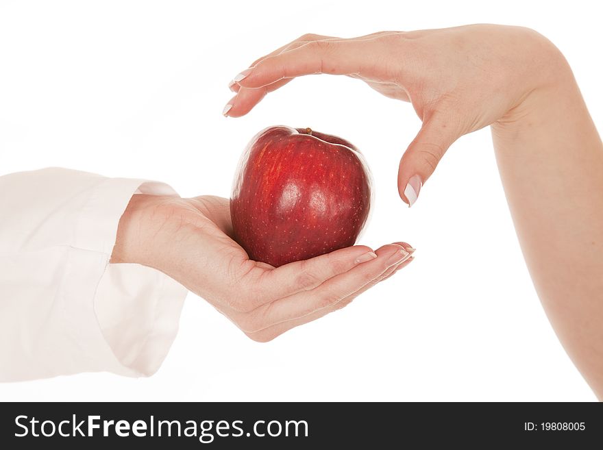 A close up of a hand getting ready to grab an apple from another person. A close up of a hand getting ready to grab an apple from another person.