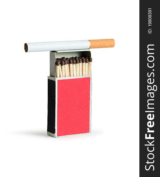 Cigarette lying on open matchbox. Isolated on white with clipping path. Cigarette lying on open matchbox. Isolated on white with clipping path
