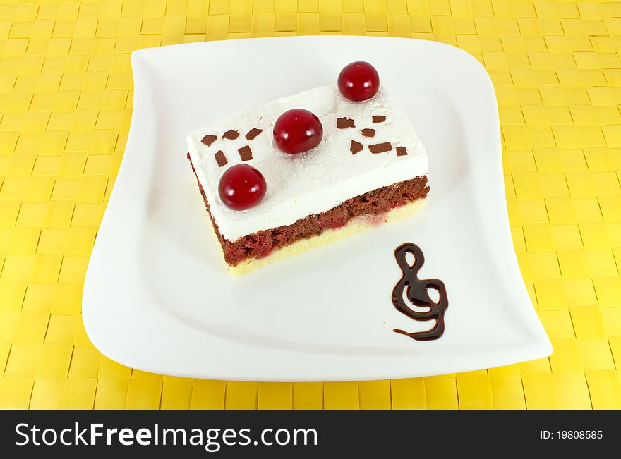 Sweet homemade cake with sour cherries on white plate