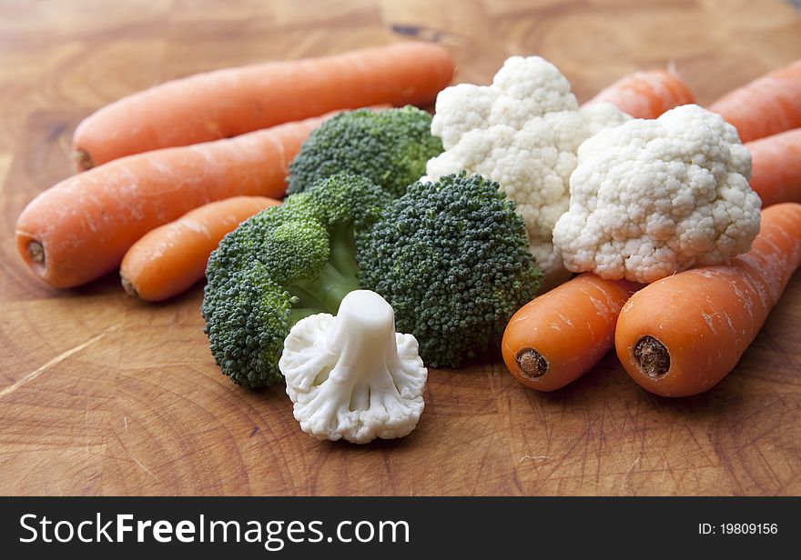 Simple arrangement of Vegetables on a wooden chopping board