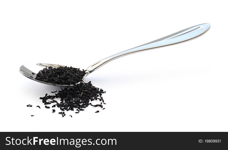 Black tea in a metal spoon