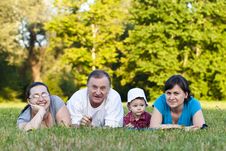 Grandpa, Daughters And Niece On Grass Stock Photo Grandpa, Daughters And Niece On Grass Stock Photo