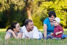 Grandpa, Daughters And Niece On Grass Stock Image Grandpa, Daughters And Niece On Grass Stock Image