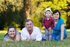 Grandpa, Daughters And Niece On Grass Stock Photos Grandpa, Daughters And Niece On Grass Stock Photos