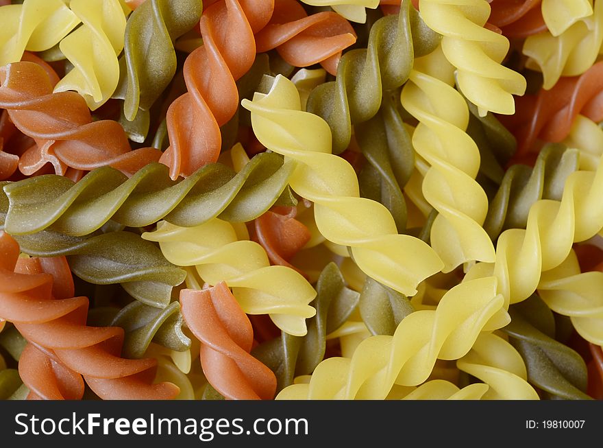 Many colorful pastas photographed with macro texture forming. Many colorful pastas photographed with macro texture forming