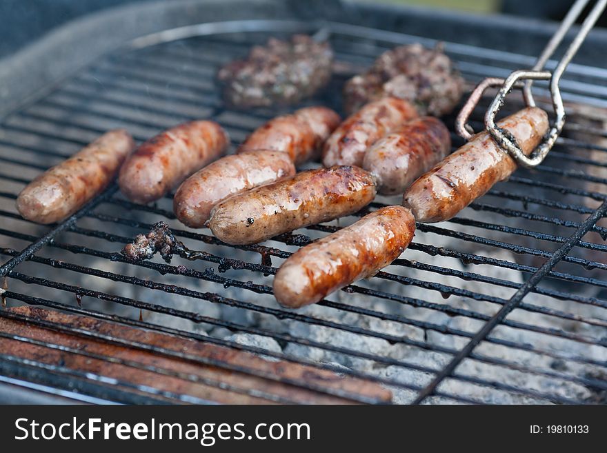 Summer BBQ with sausages and burgers. Summer BBQ with sausages and burgers