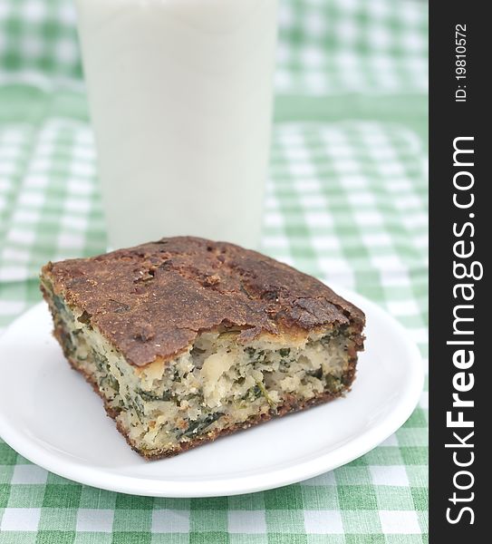 Spinach pie and milk on the table