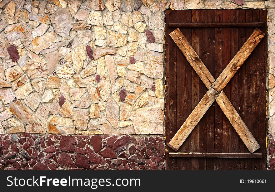 An old nailed-up door and a wall. An old nailed-up door and a wall
