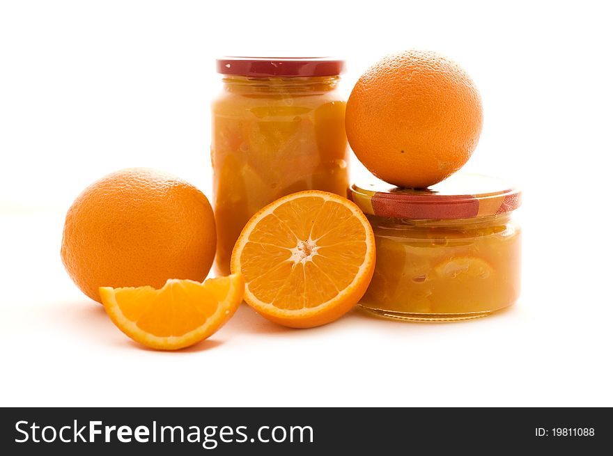 Orange marmalade and fruits isolated on white background