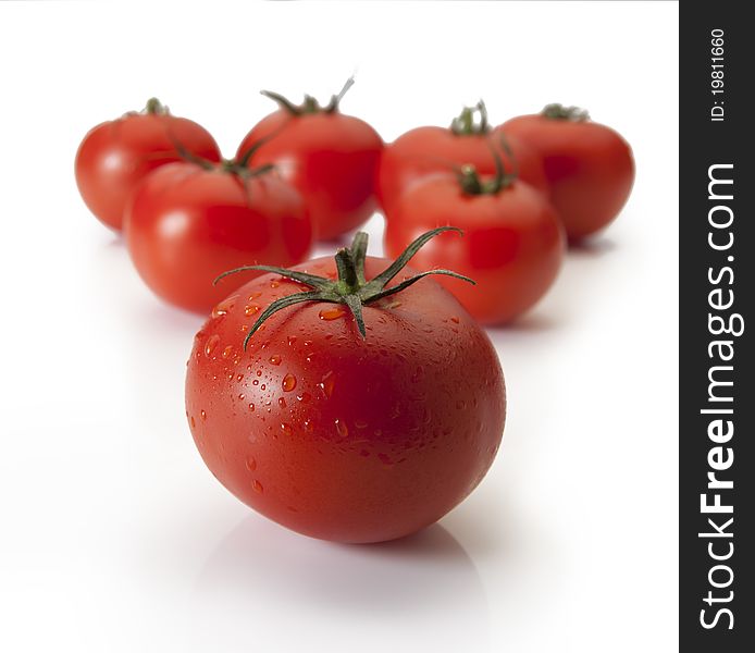 Ripe tomatoes arrange in rows on an isolated white background