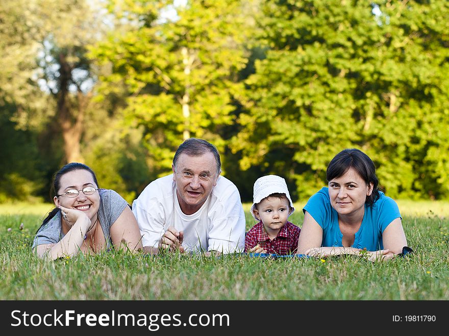 Grandpa, daughters and niece on grass