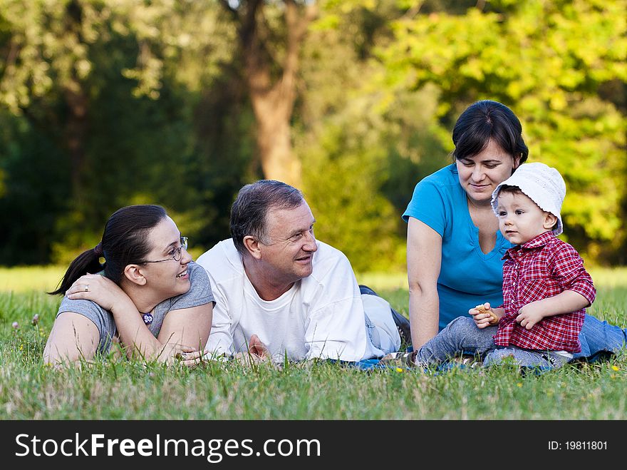 Grandpa, daughters and niece on grass