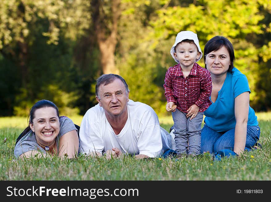 Grandpa, Daughters And Niece On Grass