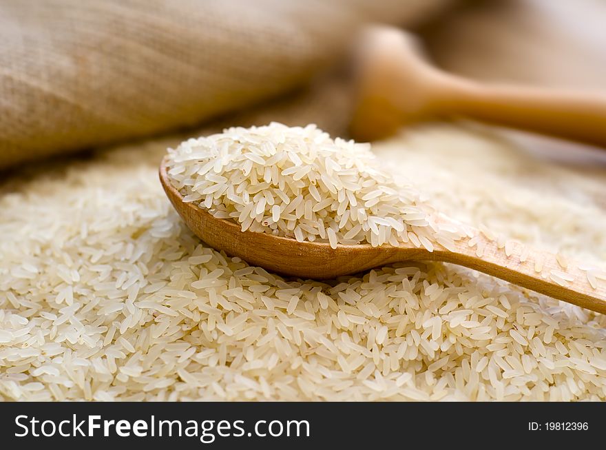 Raw rice and wooden spoon