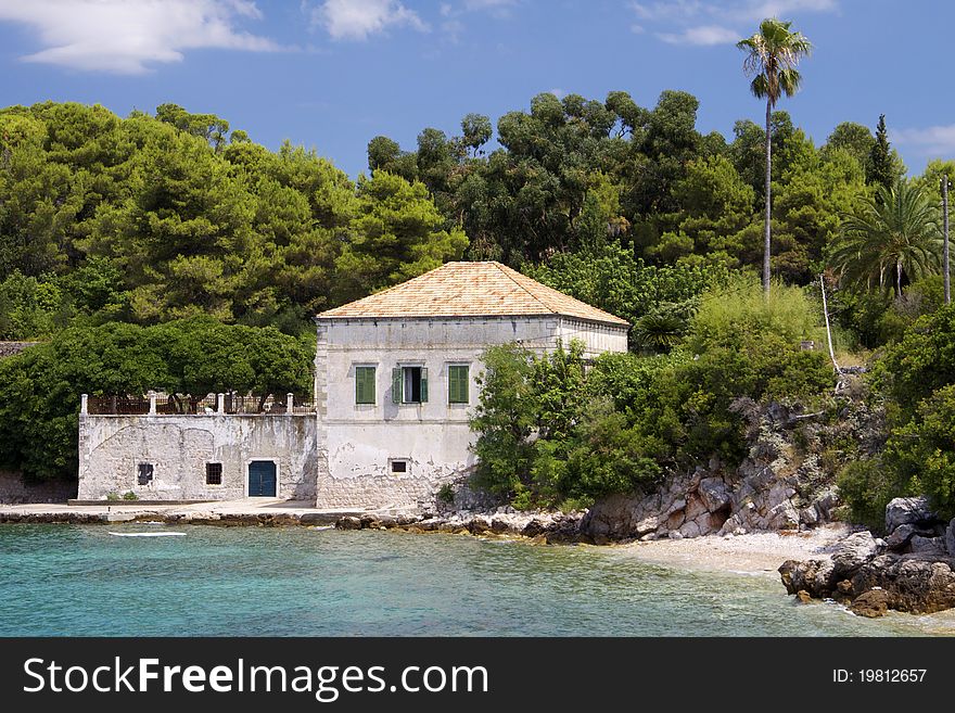 One of the Elafiti islands off shore Dubrovnik and a typical croatian house in a great summer weather. One of the Elafiti islands off shore Dubrovnik and a typical croatian house in a great summer weather.