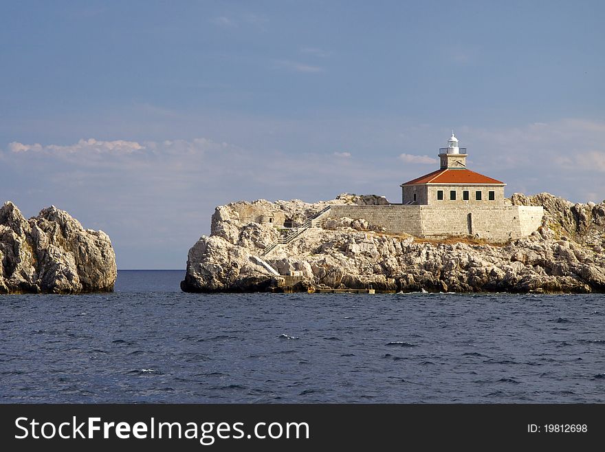 Light house on the shore of Croatia near Dubrovnik in a great summer weather. Light house on the shore of Croatia near Dubrovnik in a great summer weather.
