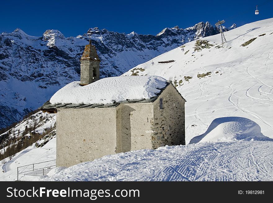 Mountain church surrounded by snow