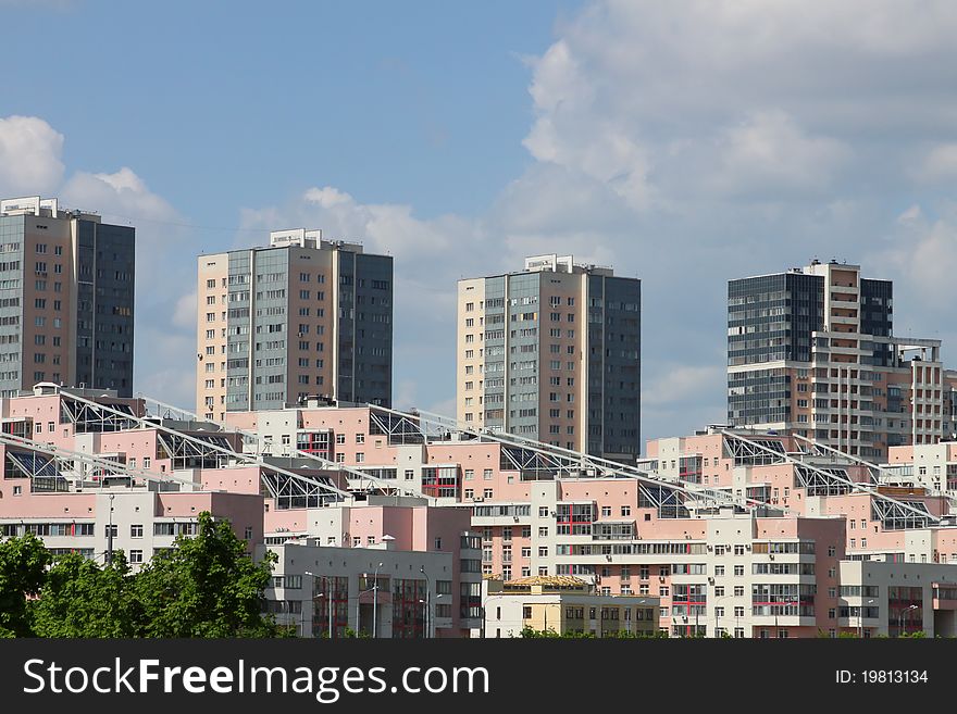 Modern multifamily housing on the blue sky