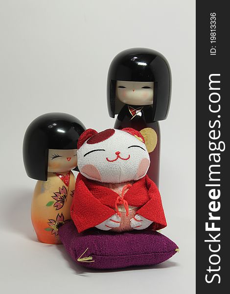Japanese dolls (boy and girl) on the white background with maneki-neko. Japanese dolls (boy and girl) on the white background with maneki-neko