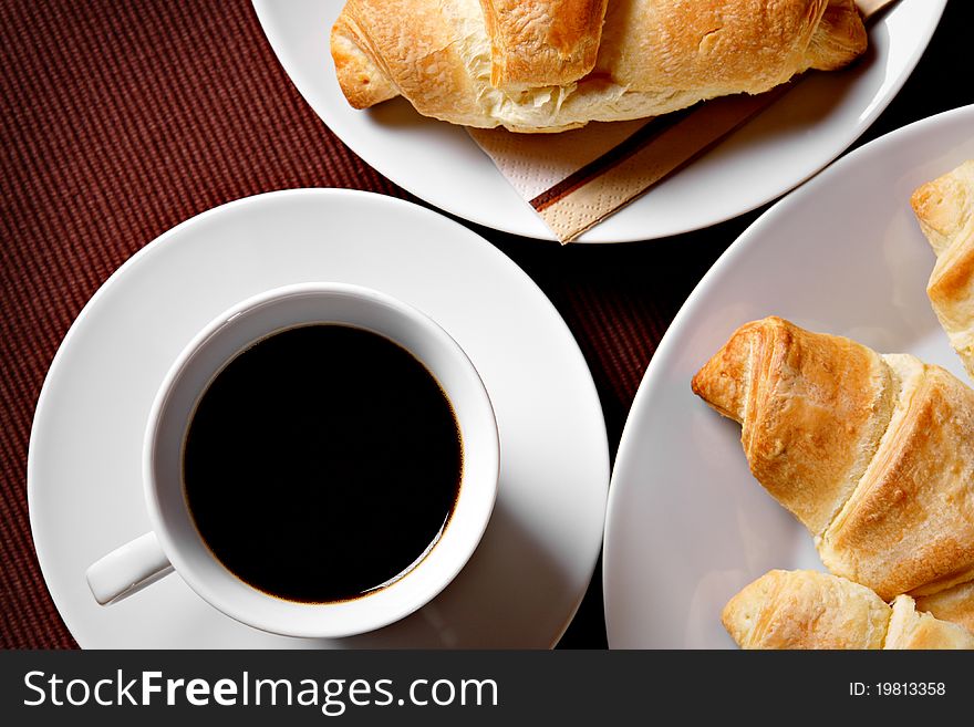 Cup of coffee with fresh warm croissants. Cup of coffee with fresh warm croissants