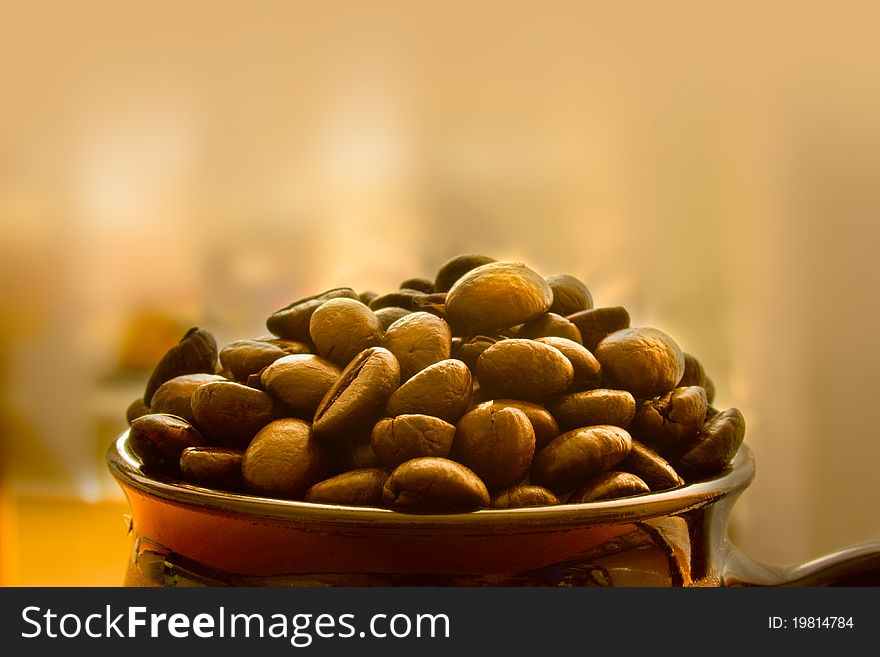 Closeup of coffee beans in a small pot with copyspace