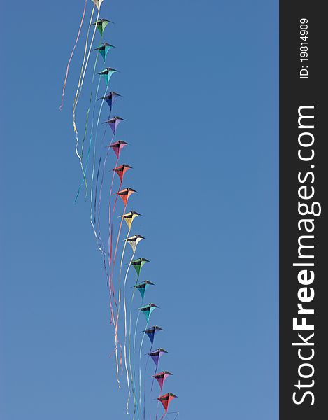 Kites against a vivid blue sky