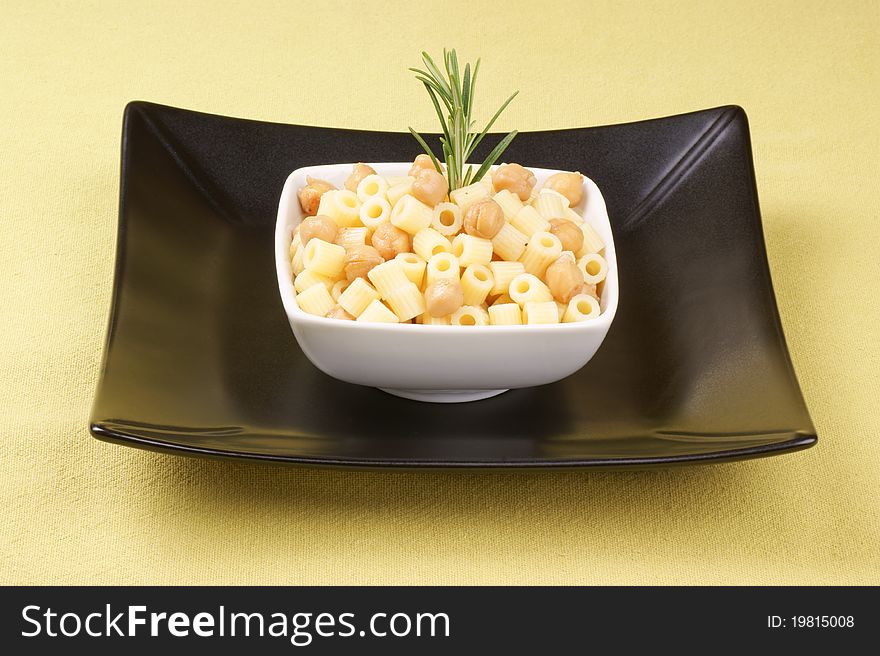 Ditalini with chickpea and rosemary served in a white plate