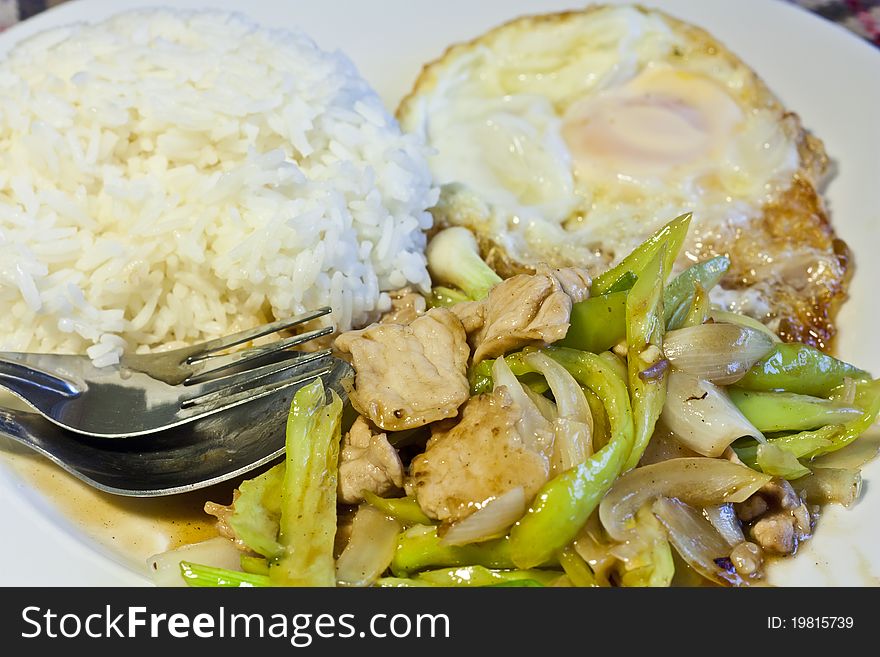 Fried pork with green chili and rice famous Thai food