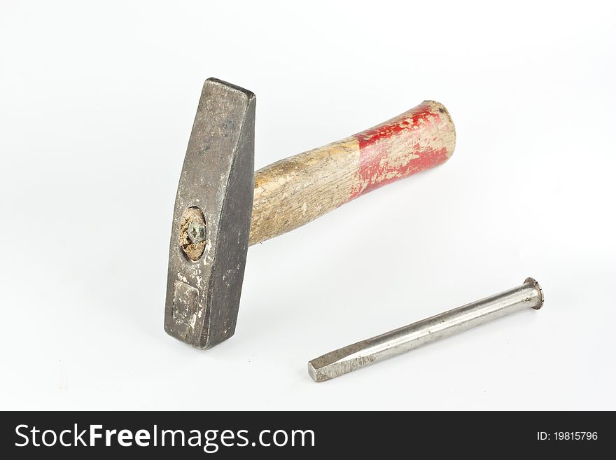 Old hammer and nail isolated on white background
