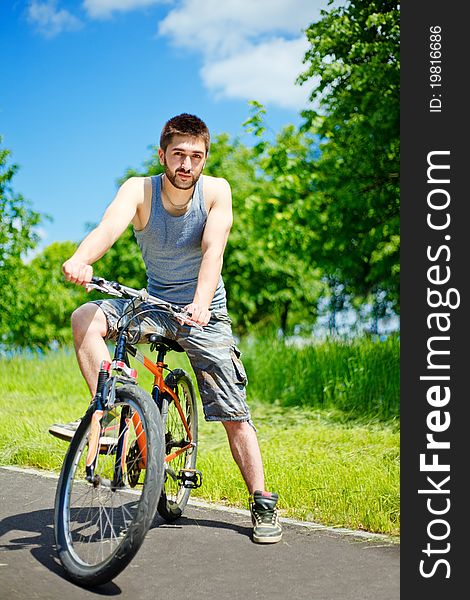 Young man cyclist sitting on bicycle