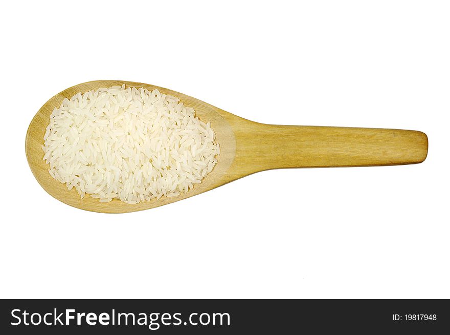 Raw rice in wooden spoon