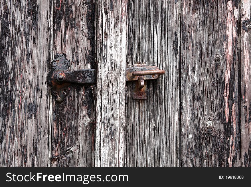 Old gray wood door with a lock